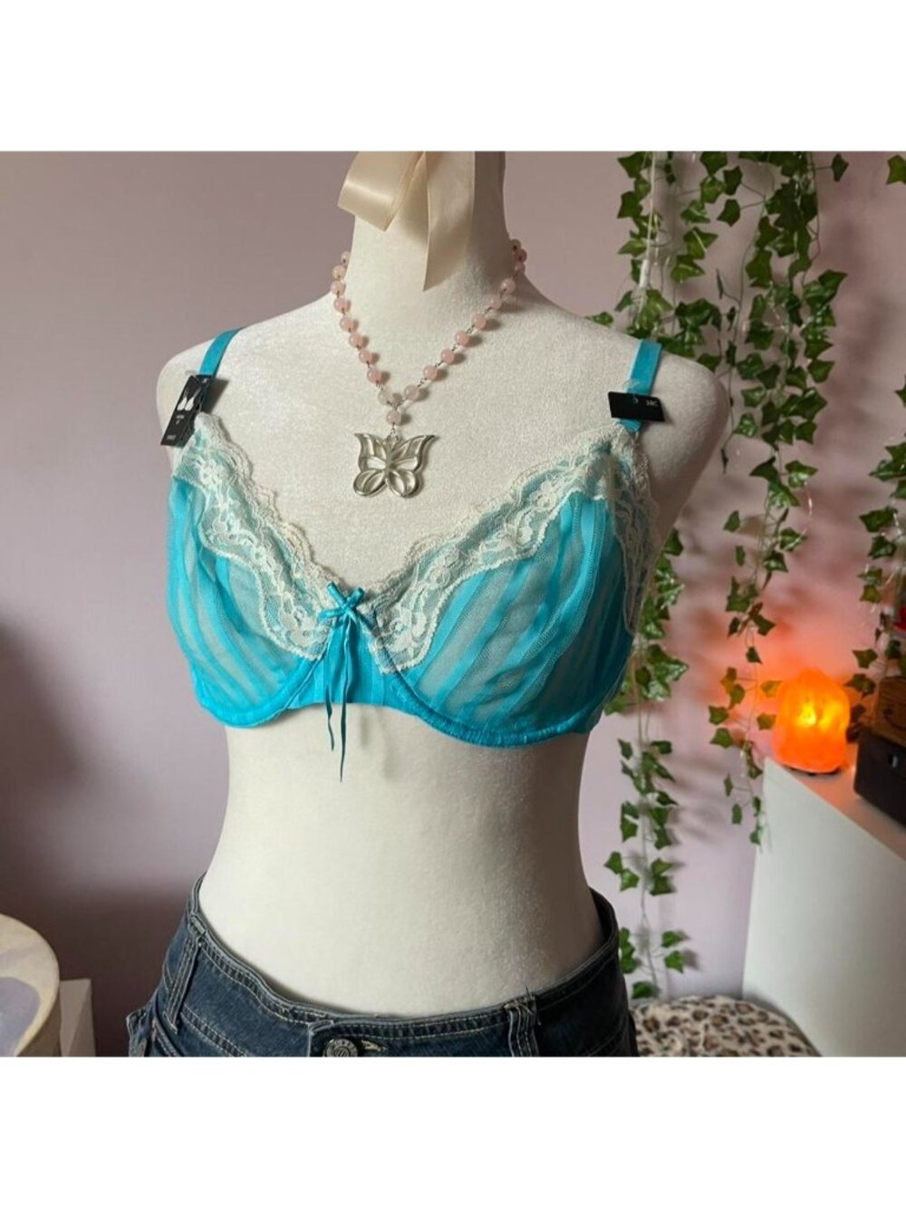 Blue lacy unlined bra with adjustable straps and bow detail